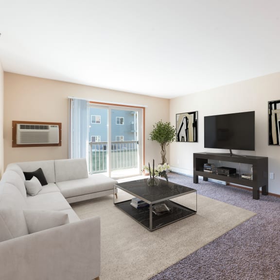 Bismarck, ND Stonefield Apartments | Living Room a living room with a couch a coffee table and a tv