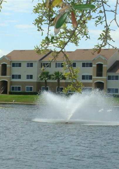 community exterior with lake views and fountain at Mission Bay Apartments, Rockledge, FL