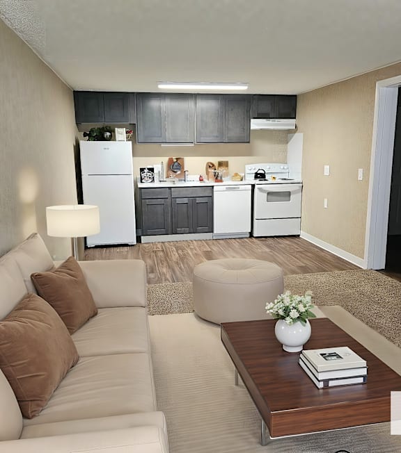 A modern living room with a couch, coffee table, and a kitchen in the background.