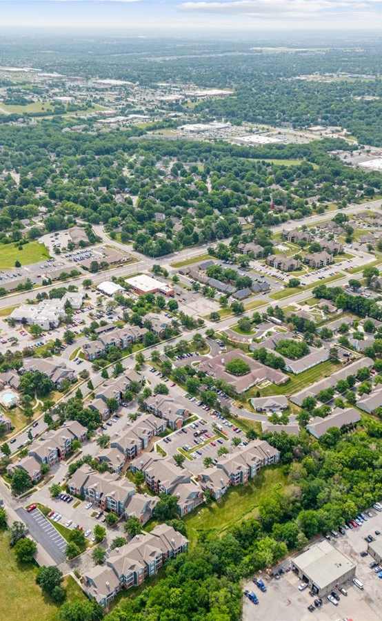 an aerial view of a city with houses and trees