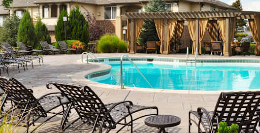 Sparkling Swimming Pool with Lounge Seating at Apartment Complex for Rent 80229