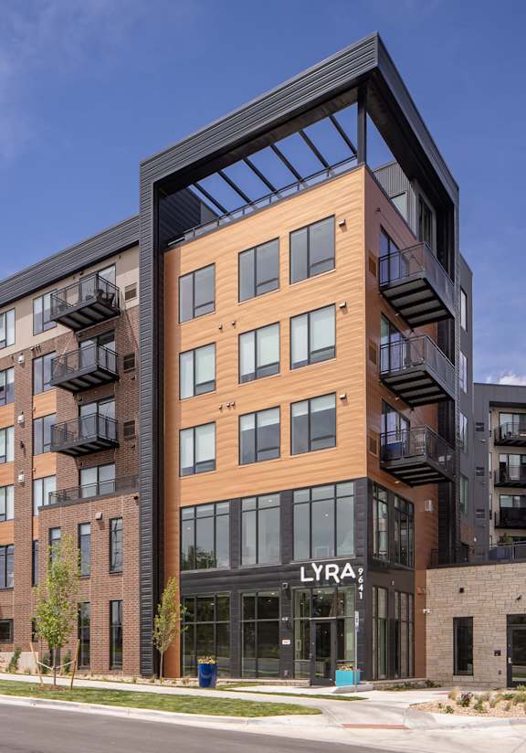A modern apartment building with the name "LYRA" on the front.
