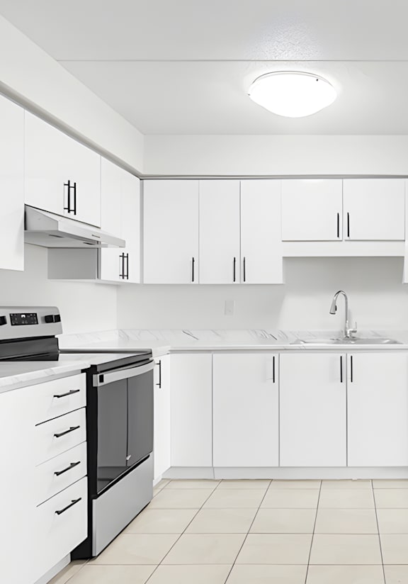 A modern kitchen with a stainless steel refrigerator and wooden flooring.