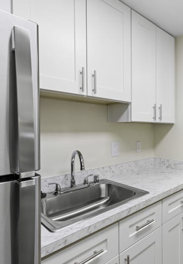 a kitchen with white cabinets and stainless steel appliances  at Casa Blanca Apartment Homes, Everett, WA, 98204