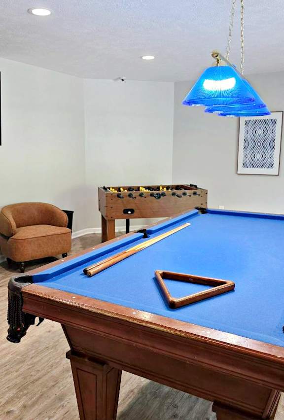 a room with a pool table and foosball table