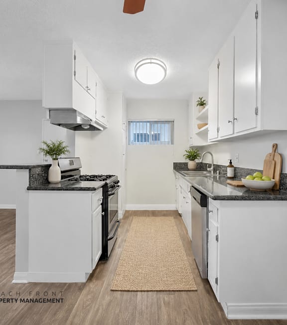 A well-lit, modern kitchen and living room with a dining area.