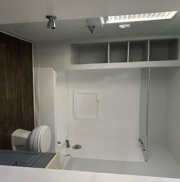 A modern bathroom with a shower and a toilet.
