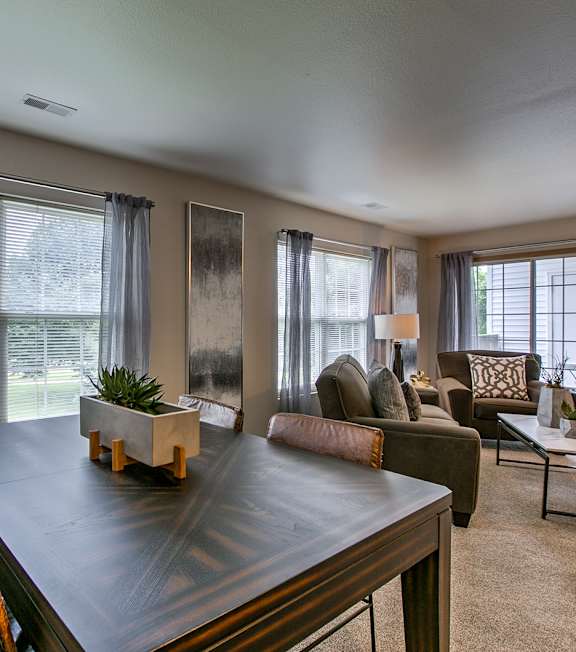 A dining room with a table and chairs.