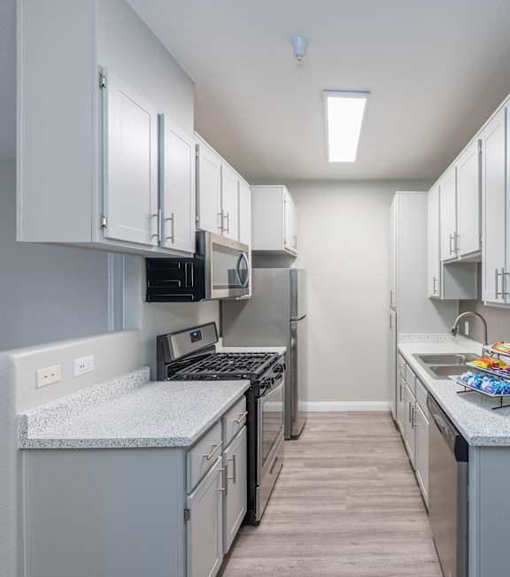 A kitchen with white cabinets and a grey countertop. at Cheyenne Villas, North Las Vegas, 89032