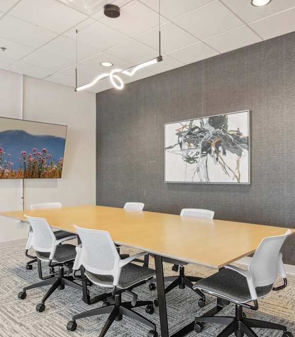 a conference room with a long table and chairs