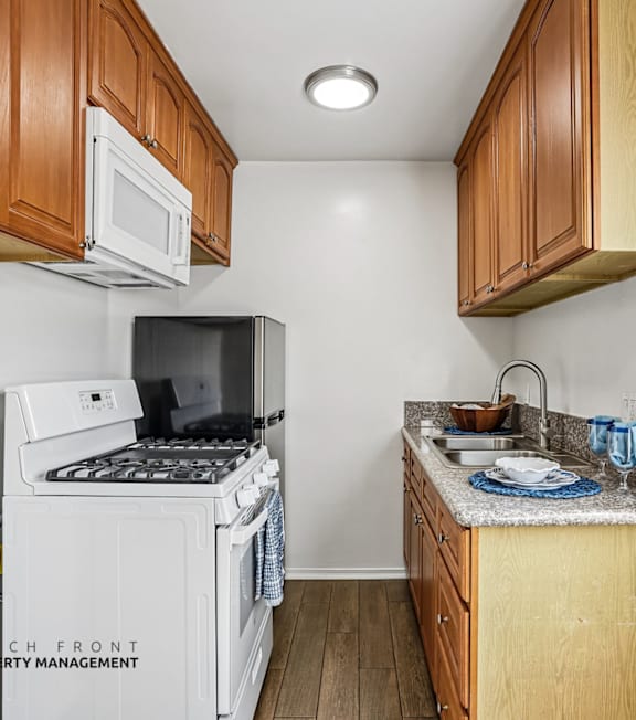 A kitchen with wooden cabinets and a white refrigerator.