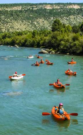 A group of people kayaking on a river.