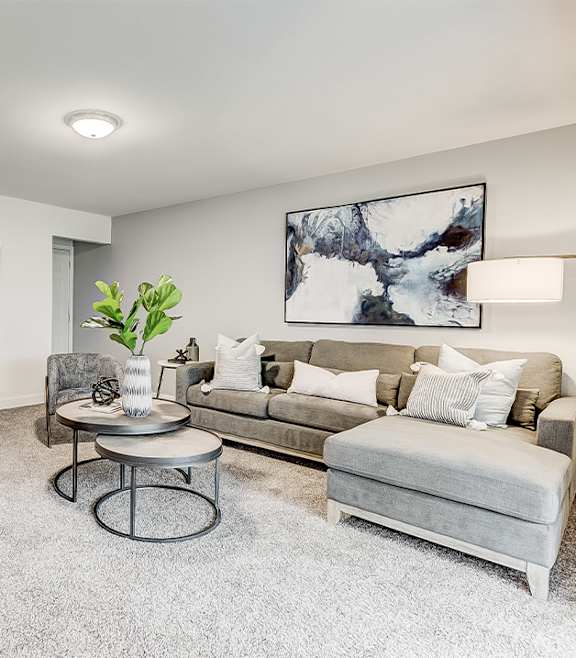 A modern living room with a blue couch and a coffee table.