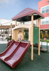 a playground with a slide and a gazebo