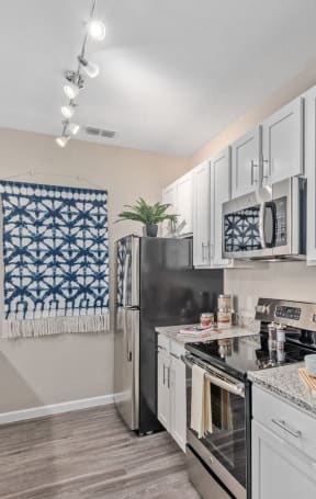 our spacious kitchen is equipped with stainless steel appliances and granite counter tops