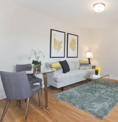 a living room with a couch and a table and chairs