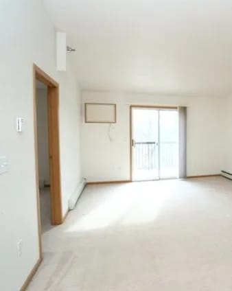 A room with a window and a door.