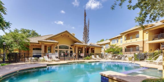 a swimming pool with a house in the background