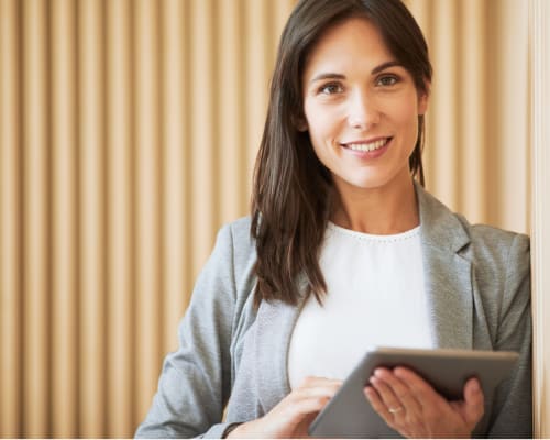 A woman is holding a tablet and smiling. at Yellowstone Landing, Montana, 59714
