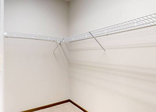 Empty walk in closet with wire racks