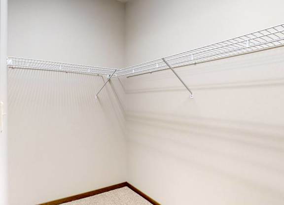 Empty walk in closet with wire racks