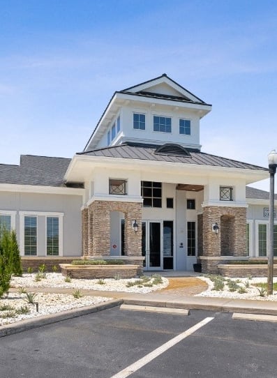 a large gray apartment building with a sidewalk in front of it at Village at Terra Bella Apartments, Land O' Lakes, Florida
