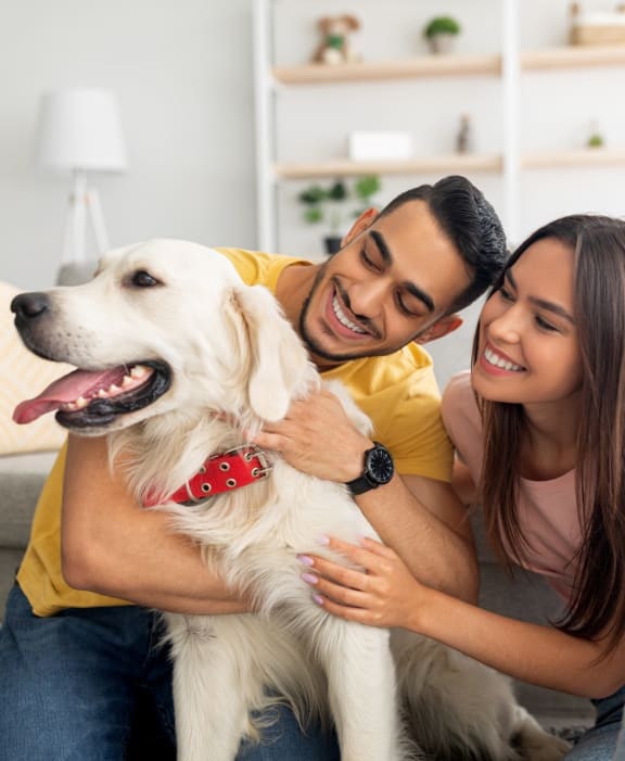 Young Couple with Adorable Dog Smiling