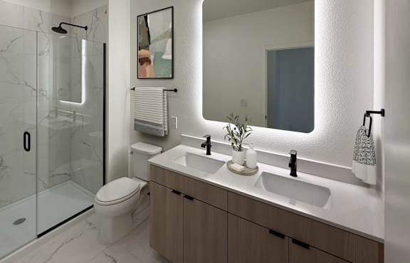 A modern bathroom with a walk-in shower, double sinks, and a large mirror.