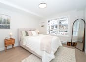 Thumbnail 6 of 7 - Bedroom with a Nightstand at Woodland Place Apartments, Langford