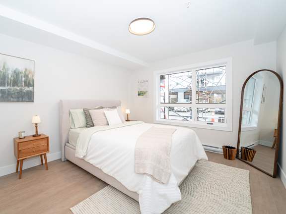 Bedroom with a Nightstand at Woodland Place Apartments, Langford