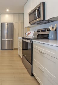 a kitchen with a stove top oven next to a sink