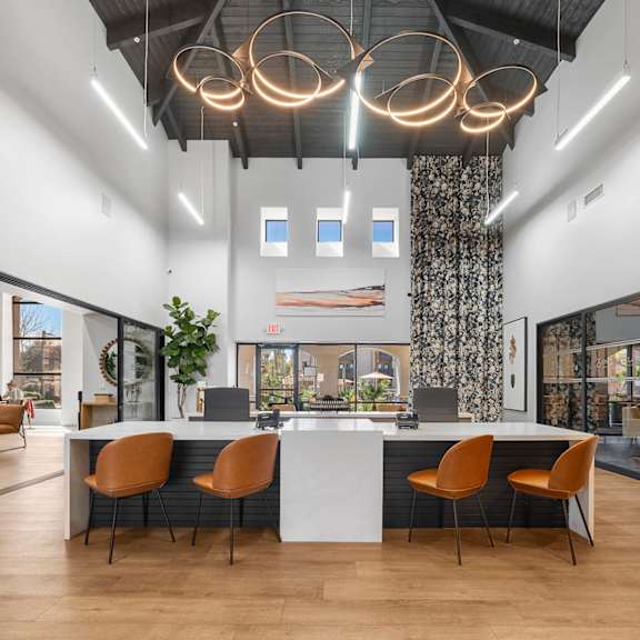 A modern office space with a long table and chairs.