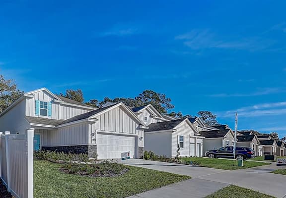 a row of houses on a street with a blue sky in the background