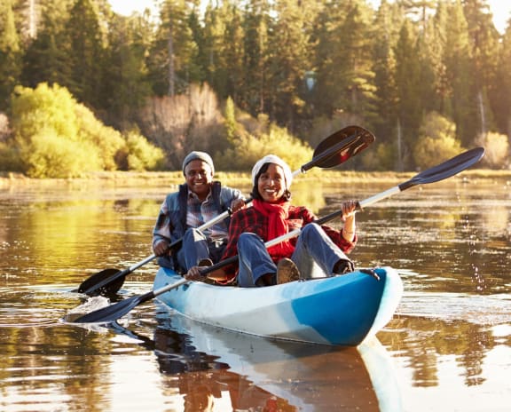 Older Couple in Winter Clothes Kayaking