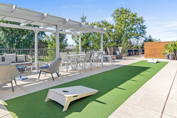 a patio with tables and chairs and a pergola