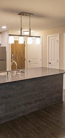 a kitchen with white cabinets and a black stove and refrigerator