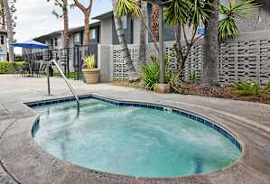 A small pool with a slide in the middle of it.