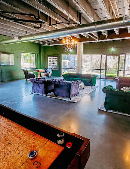 A billiard table is in the foreground of this image.