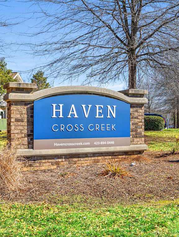 a large lawn in front of a building with a sign that says hawken community center