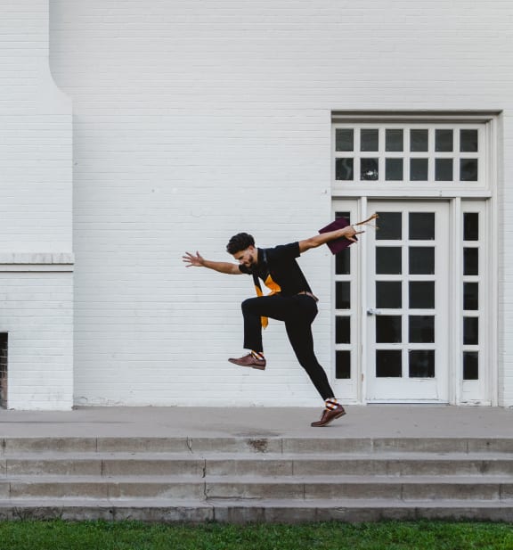 a man doing a trick on a skateboard on the steps