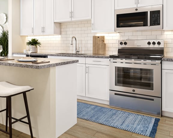 a kitchen and living room with white cabinets and a counter top