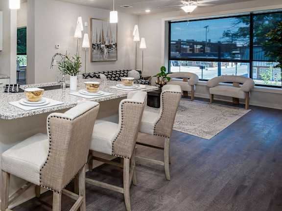 an open kitchen and living room with a table and chairs