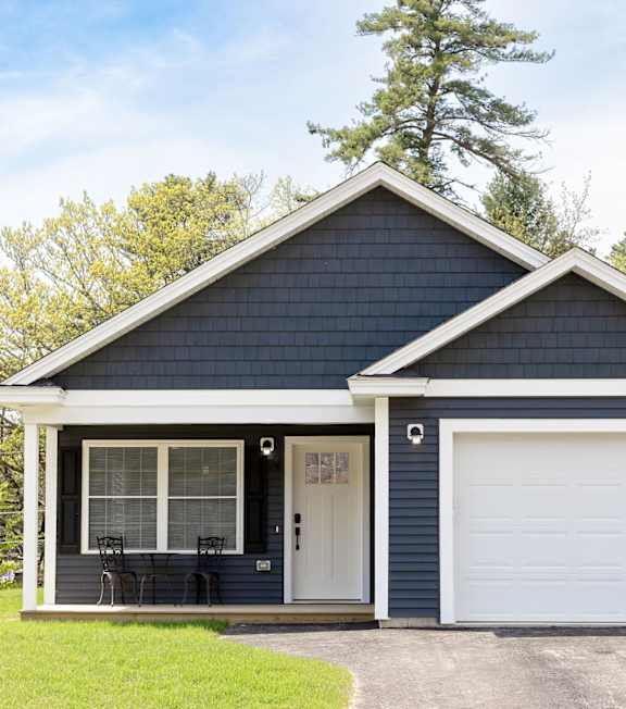 A two-car garage with a white door and a small porch.
