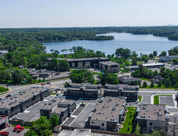 an aerial view of a city with a lake in the background