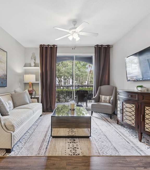 A living room with a couch, a chair, a coffee table, and a painting on the wall.