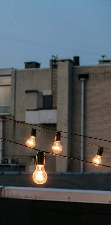 A string of light bulbs is strung across a wire.
