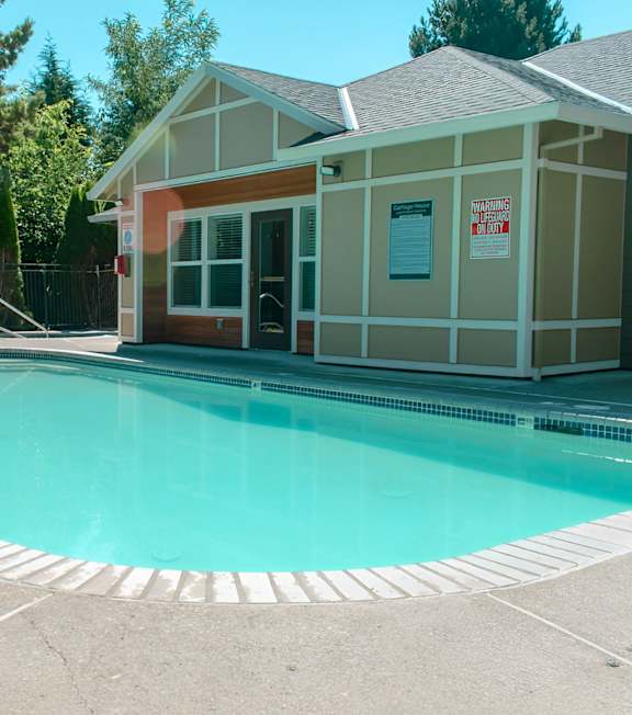 A pool with a building next to it.