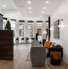 A reception area with a wooden desk and a chair.