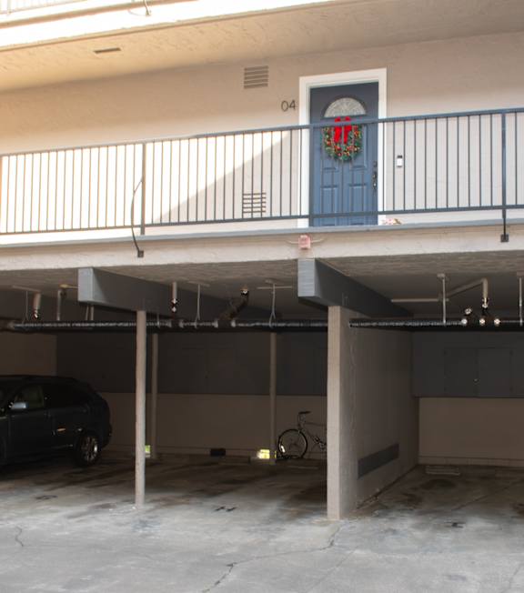 A small pool in a courtyard surrounded by apartment buildings.