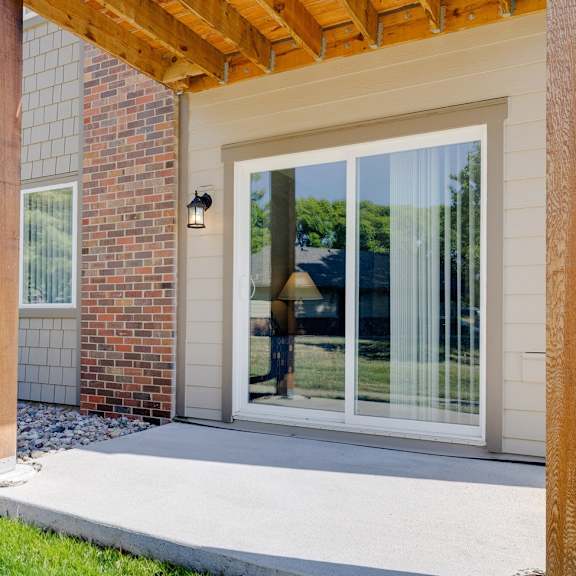Patio sliding door in a Regency Woods model unit, with a view of the exterior side of the apartment.